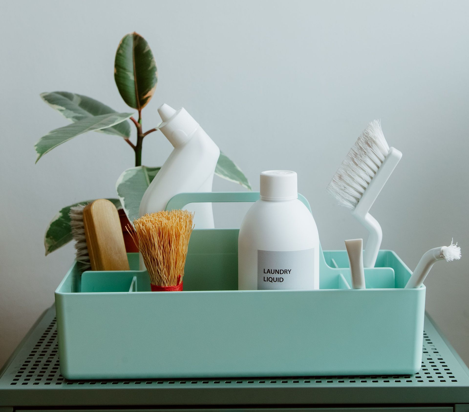 Minimalist display of eco-friendly cleaning products in pastel organizer, highlighting sustainable living.